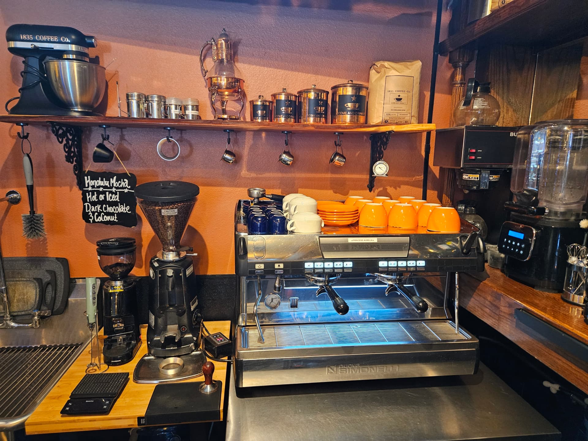 Espresso machine, grinders and orange cups at the 1835 Coffee Company bar in Mineola, Texas